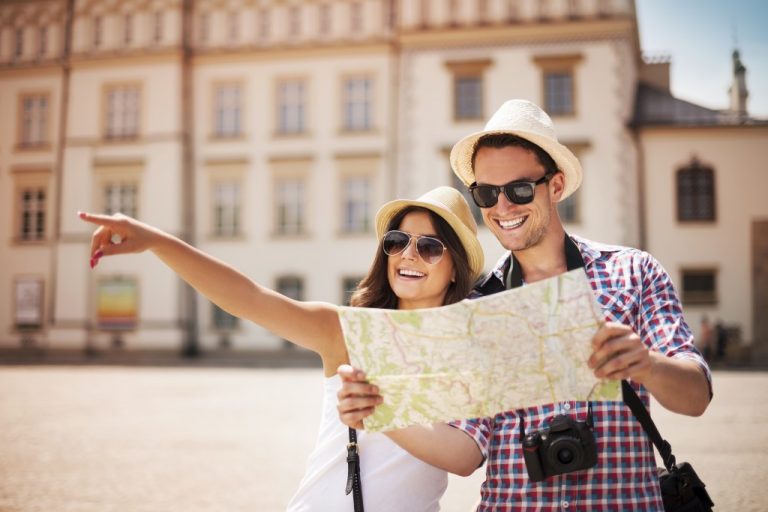 Happy tourists sightseeing city with map