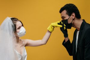 bride and groom wearing masks
